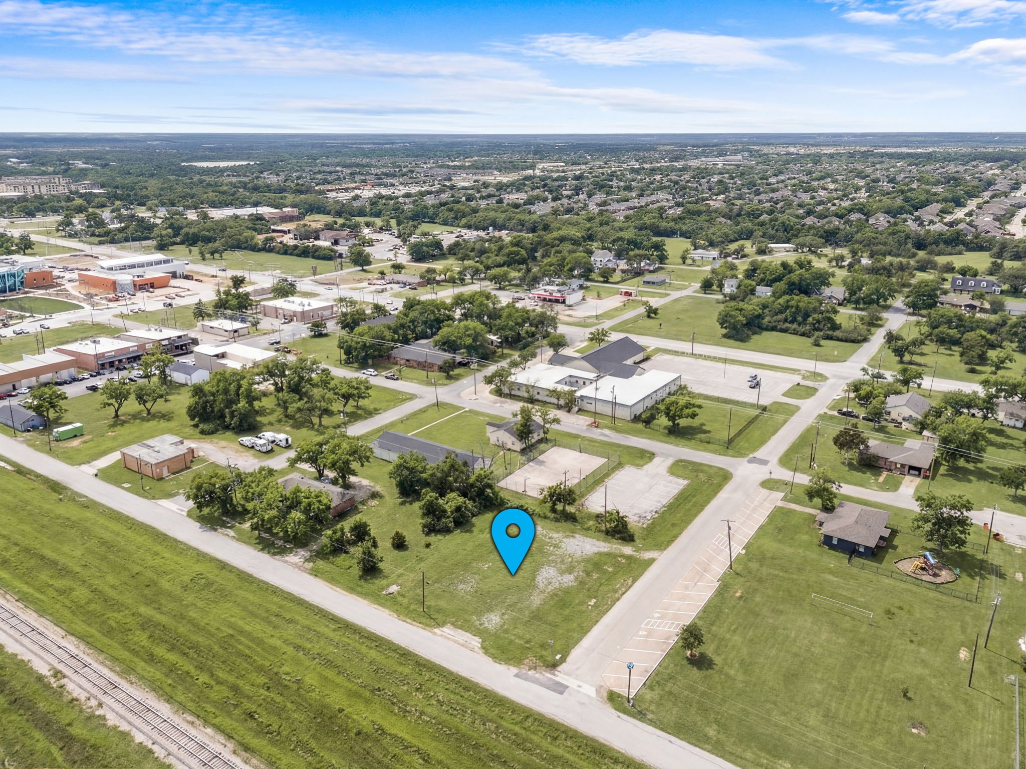 Wide aerial view of 211 N Riggins lot with downtown Anna in background