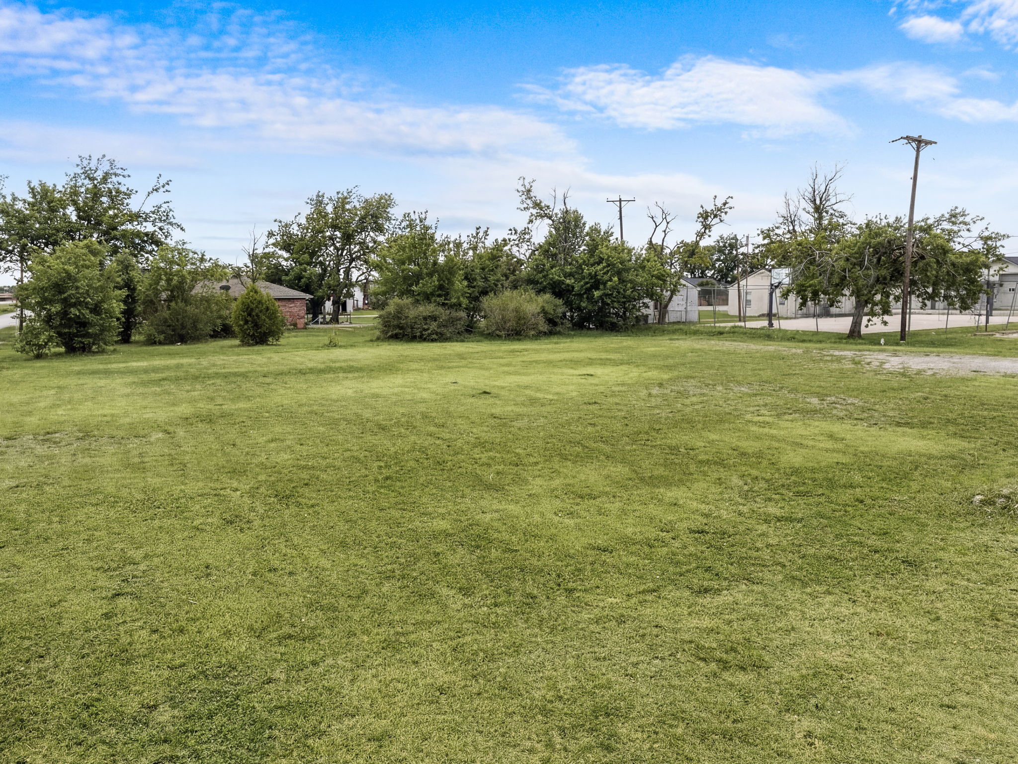 Ground-level view of the vacant lot looking across the open parcel
