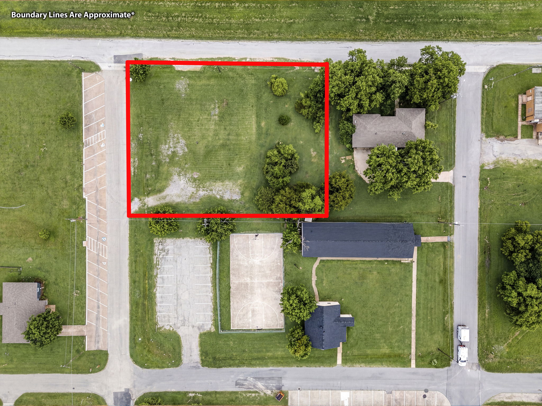 Overhead aerial with red boundary lines marking approximate lot lines